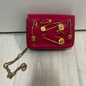 VERSACE fuchsia handbag.